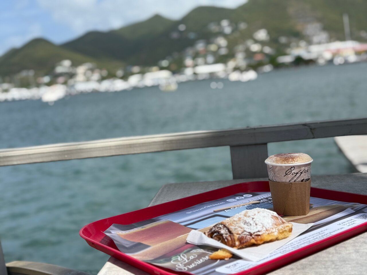 Coffee and a pastry on the waterfront overlooking Great Bay and the hills of Philipsburg