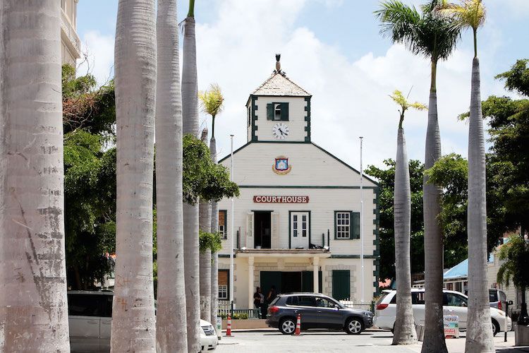 The historic Courthouse on Front Street in Philipsburg, St. Maarten, framed by royal palms